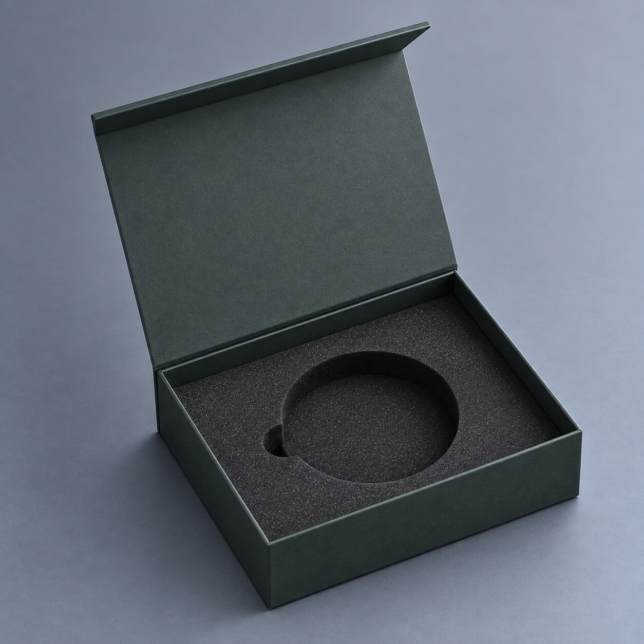custom packaging | rigid box with circular foam insert and embossed lid detail