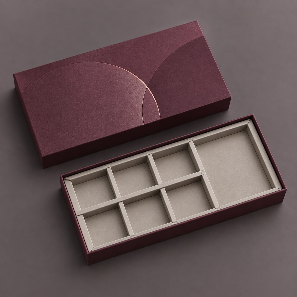 custom packaging | rigid box with multi-compartment paperboard divider insert and embossed burgundy lid