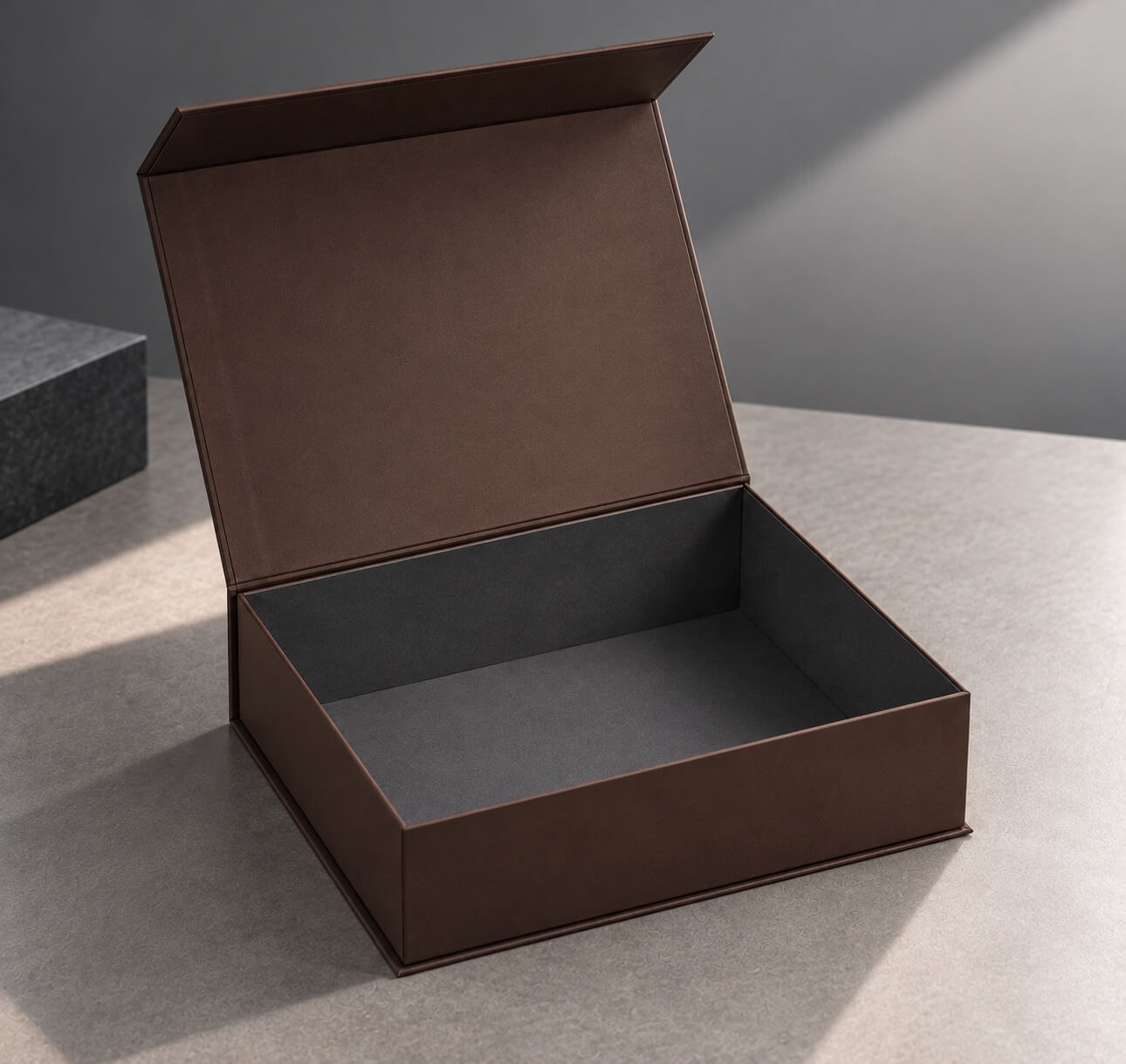 luxury packaging | open magnetic rigid gift box with dark gray interior and matte brown exterior